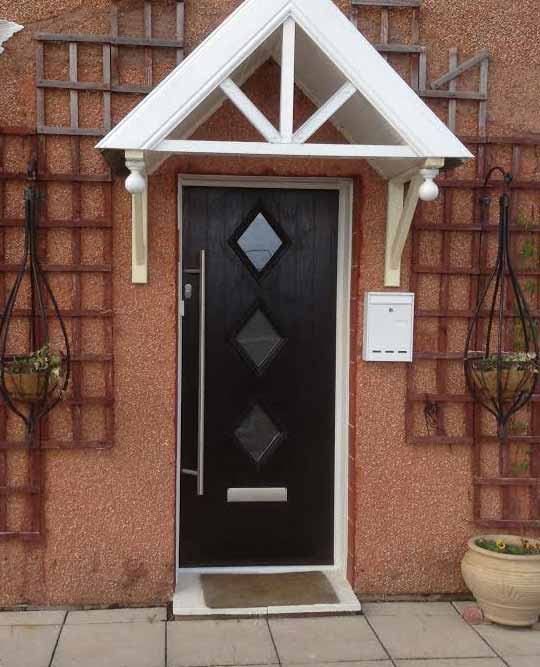 black front door with stainless steel bar handle