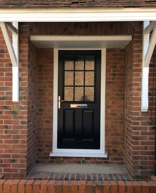 pre hung black front door with a white frame
