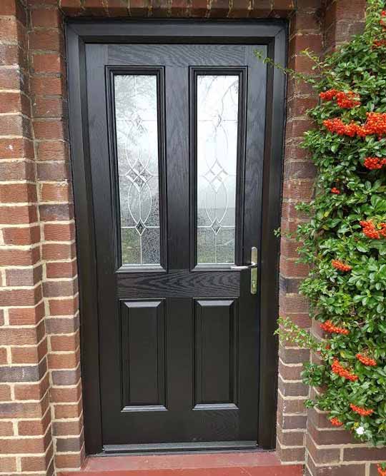 black composite front door with triple glazing in a black frame