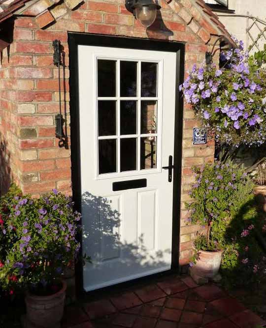 cottage door in white witrh georgian bars